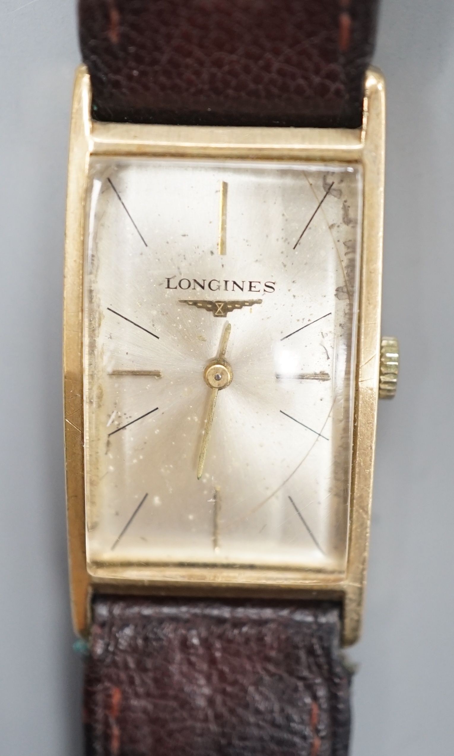 A gentleman's 14k Longines manual wind rectangular dial wrist watch, case diameter 20mm, on associated leather strap.